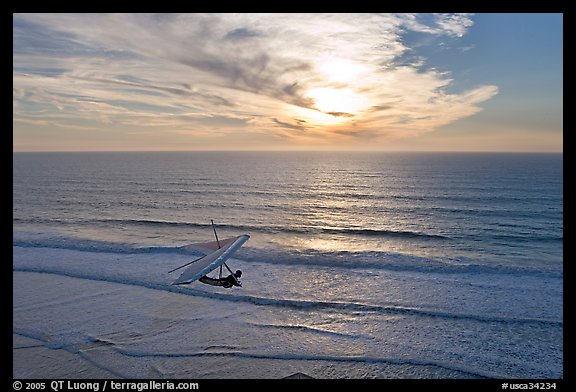 Hang glider flying  above ocean, Fort Funston, sunset. San Francisco, California, USA (color)