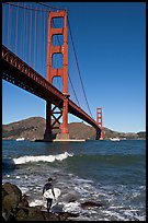Surfer and wave below the Golden Gate Bridge. San Francisco, California, USA (color)