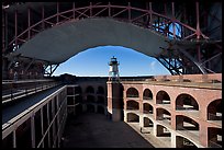 Fort Point courtyard, lighthouse,  and arch of the Golden Gate Bridge. San Francisco, California, USA