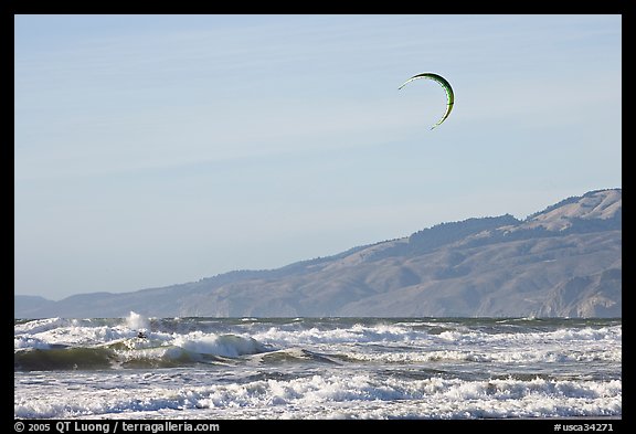Kite surfer in Pacific Ocean waves, afternoon. San Francisco, California, USA (color)