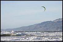 Kite surfer in Pacific Ocean waves, afternoon. San Francisco, California, USA