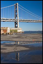 Bay Bridge reflected in water puddles. San Francisco, California, USA ( color)