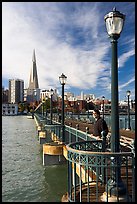 Visitor standing on pier 7, morning. San Francisco, California, USA