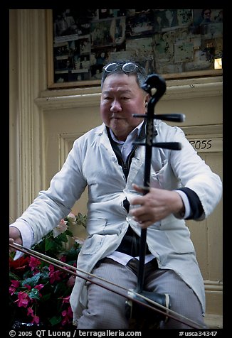 Chinese man playing the traditional Ehru, Chinatown. San Francisco, California, USA