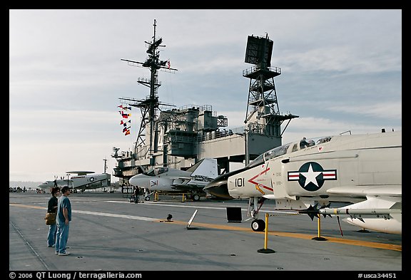 Couple looking at fighter aircraft on the Flight deck of USS Midway. San Diego, California, USA (color)