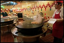 Cook preparing Mongolian BBQ, Horton Plaza. San Diego, California, USA (color)