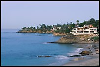 Rocky coastline with waterfront houses at dawn. Laguna Beach, Orange County, California, USA (color)
