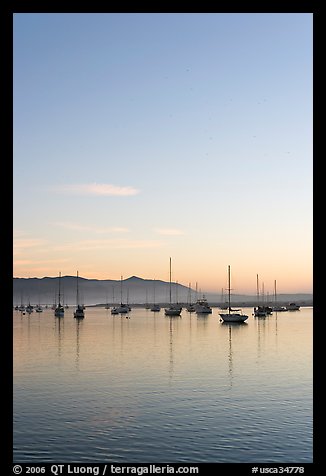 Yachts reflected in Morro Bay harbor, sunset. Morro Bay, USA