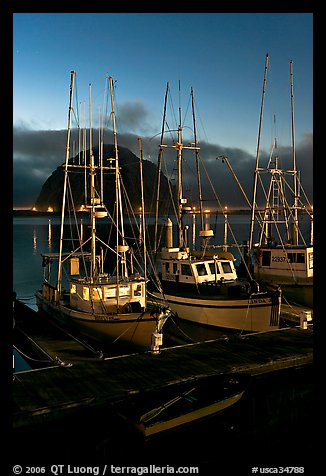 Lighted fishing boats and Morro Rock. Morro Bay, USA
