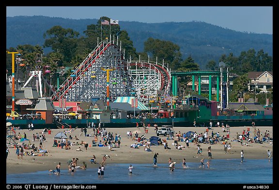 Beachgoers, and Santa Cruz boardwalk roller-coaster. Santa Cruz, California, USA (color)