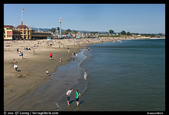 Beach with couple standing in water. Santa Cruz, California, USA