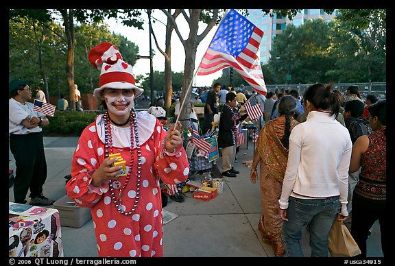 Woman in clown costume waiving American Flag, Independence Day. San Jose, California, USA