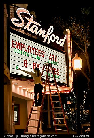 Woman changing movie title, Stanford Theatre. Palo Alto,  California, USA