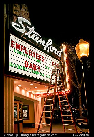 Woman on ladder arranging sign letters, Stanford Theater. Palo Alto,  California, USA