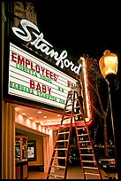 Woman on ladder arranging sign letters, Stanford Theater. Palo Alto,  California, USA ( color)