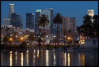 Skyline and lights reflected in a lake in Mc Arthur Park. Los Angeles, California, USA