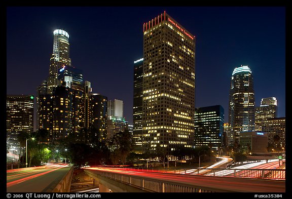 Bridge, traffic lights and Los Angeles skyline at night. Los Angeles, California, USA