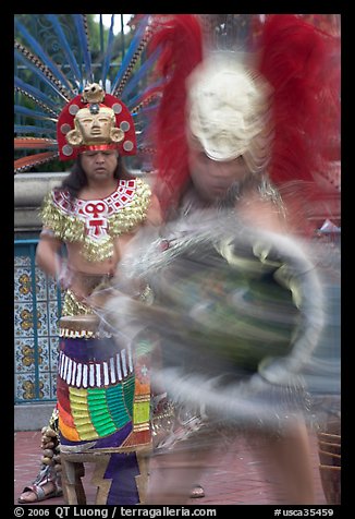 Aztec dancers in motion,  El Pueblo historic district. Los Angeles, California, USA (color)