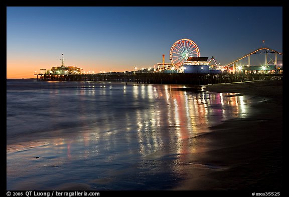 Pier and Ferris Wheel reflected on beach at dusk. Santa Monica, Los Angeles, California, USA (color)