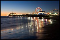Pier and Ferris Wheel reflected on beach at dusk. Santa Monica, Los Angeles, California, USA (color)