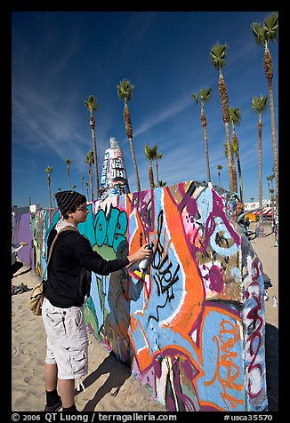 Young man making graffiti on a wall. Venice, Los Angeles, California, USA
