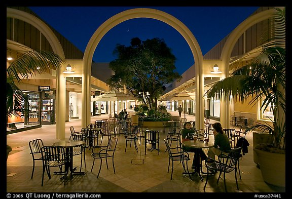 Sitting at outdoor table at night, Stanford Shopping Center. Stanford University, California, USA (color)