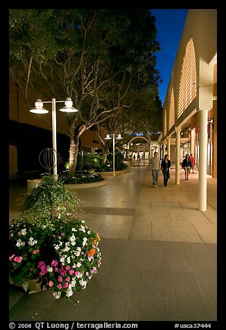 Couple walking by stores and flowers, Stanford Shopping Center. Stanford University, California, USA (color)