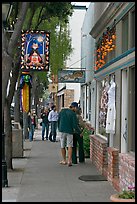 People looking at store display on Main Street. Half Moon Bay, California, USA ( color)