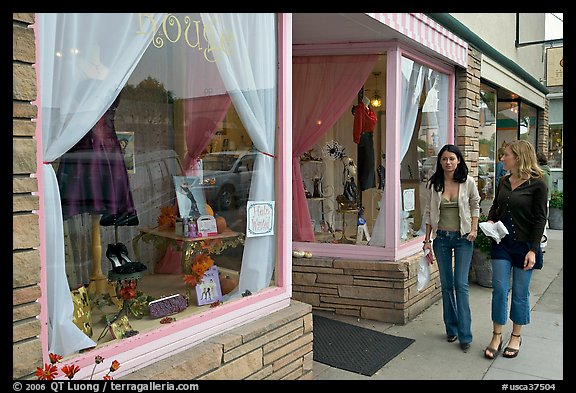 Women walking by storefront on Main Street. Half Moon Bay, California, USA (color)