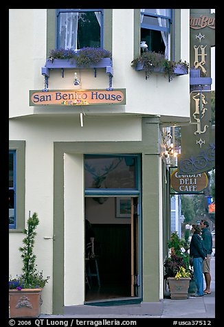 Entrance of historic San Benito House, with couple looking. Half Moon Bay, California, USA (color)