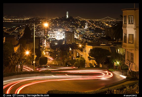 Sharp switchbacks on Russian Hill with Telegraph Hill in the background, night. San Francisco, California, USA