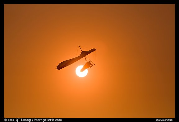 Hang glider in front of setting sun. San Francisco, California, USA