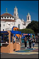 School fair booth, children, and Mission Dolores in the background. San Francisco, California, USA (color)
