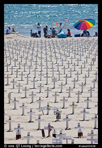 War memorial and families at edge of water on beach. Santa Monica, Los Angeles, California, USA