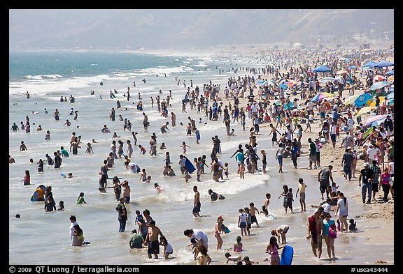 Crowds of beachgoers in water. Santa Monica, Los Angeles, California, USA