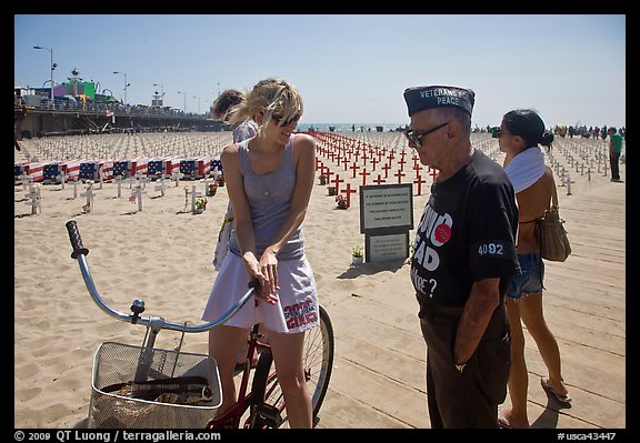 Veteran for peace conversing with woman on bicycle. Santa Monica, Los Angeles, California, USA (color)