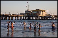 People bathing in ocean and Santa Monica Pier, late afternoon. Santa Monica, Los Angeles, California, USA ( color)