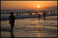 Ocean bathers at sunset, Santa Monica Beach. Santa Monica, Los Angeles, California, USA