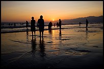 People and reflections on beach at sunset, Santa Monica Beach. Santa Monica, Los Angeles, California, USA ( color)
