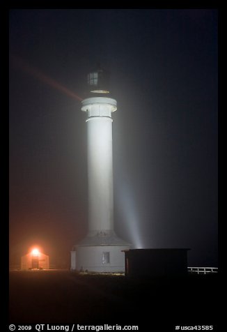 Point Arena Lighthouse on foggy night. California, USA