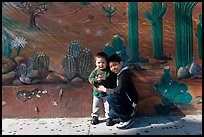 Boys and mural, Mission District. San Francisco, California, USA (color)