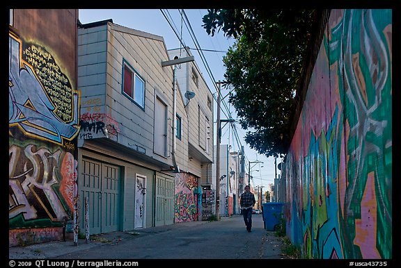 Man walking in alley, Mission District. San Francisco, California, USA (color)