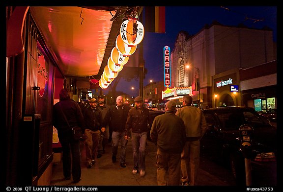 Men walking on sidewalk, Castro street at night. San Francisco, California, USA