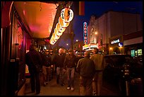 Men walking on sidewalk, Castro street at night. San Francisco, California, USA ( color)