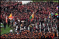 Academic flags exit amongst crow of graduates after commencement ceremony. Stanford University, California, USA ( color)