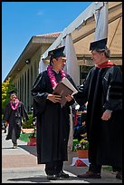 Graduate wearing lei presented with diploma. Stanford University, California, USA ( color)