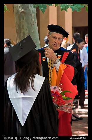 Faculty in academic dress talks with student. Stanford University, California, USA (color)
