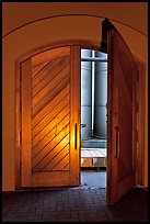 Wooden door opening to wine storage tanks. Napa Valley, California, USA