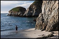 Boy standing at the base of bluff, China Cove. Point Lobos State Preserve, California, USA ( color)