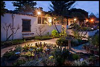 Garden and historic adobe house at night. Monterey, California, USA